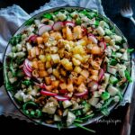 Apple, Melon And Pineapple Salad With Balsamic Vinegar on a large plate with white napkin and a fork