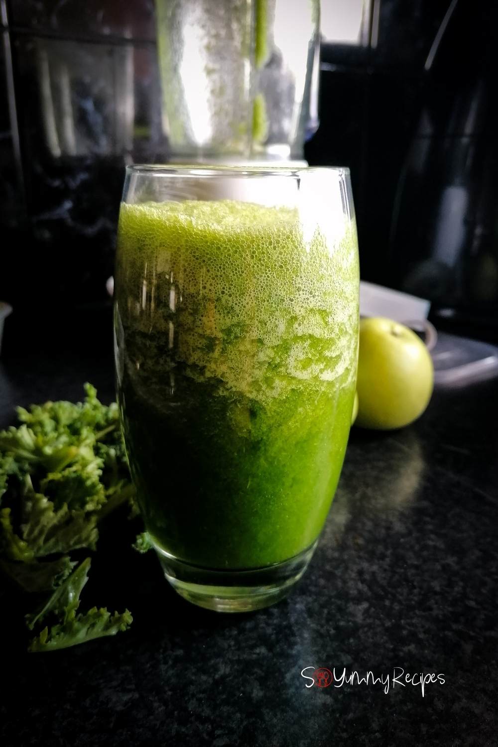 a tall glass of apple and kale smoothie