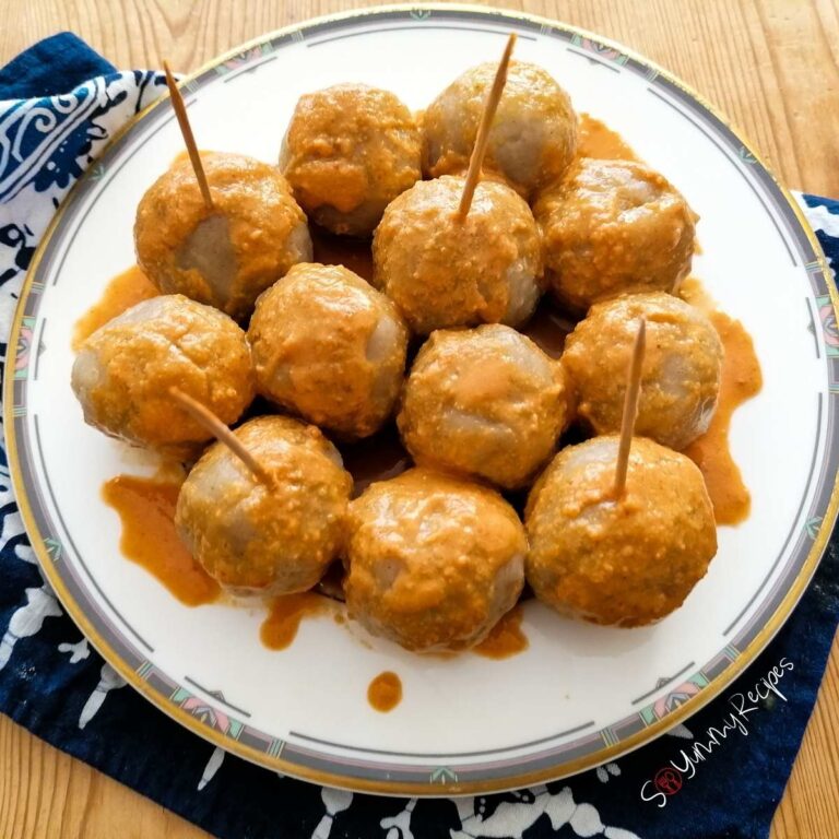 a plate of Cilok - Indonesian tapioca balls drizzled with spicy peanut sauce