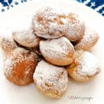 Poffertjes the Dutch mini pancakes on a white plate