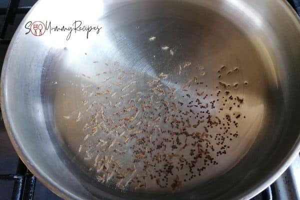 sizzling whole cumin seeds and black mustard seeds