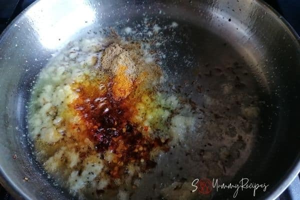 frying ginger garlic paste with the spices