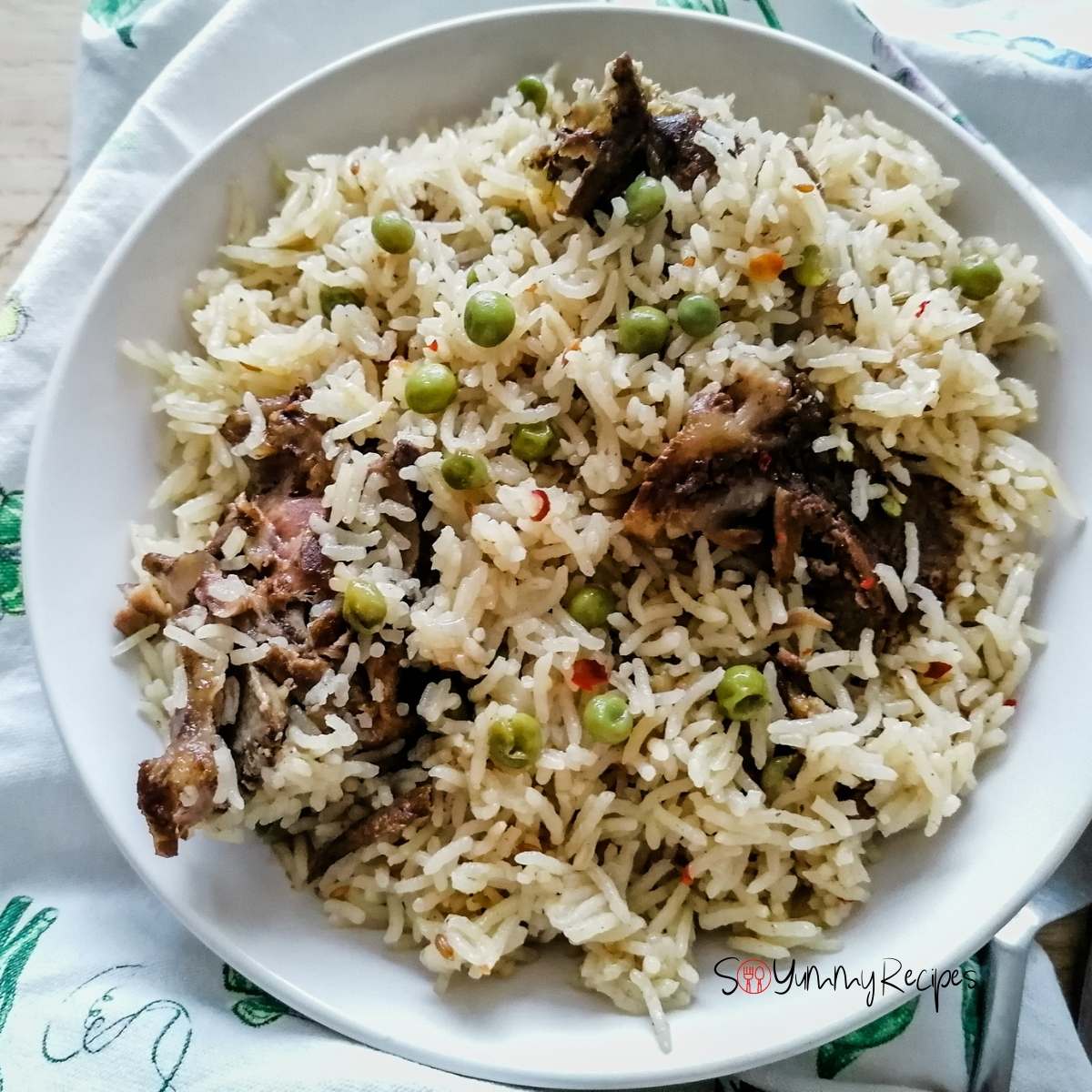 Pakistani Yakhni mutton pulao rice on a white round plate.
