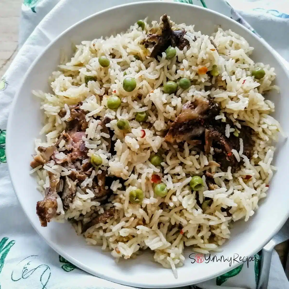 Pakistani Yakhni mutton pulao rice on a white round plate.
