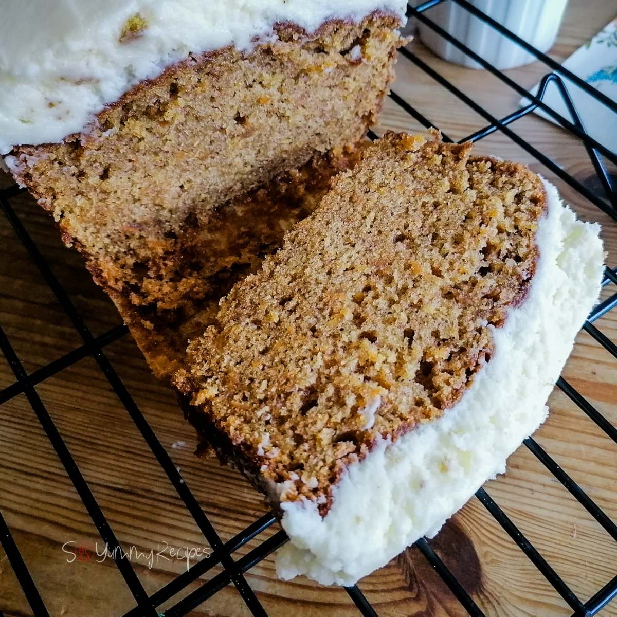 a piece of carrot cake loaf on a cooling rack