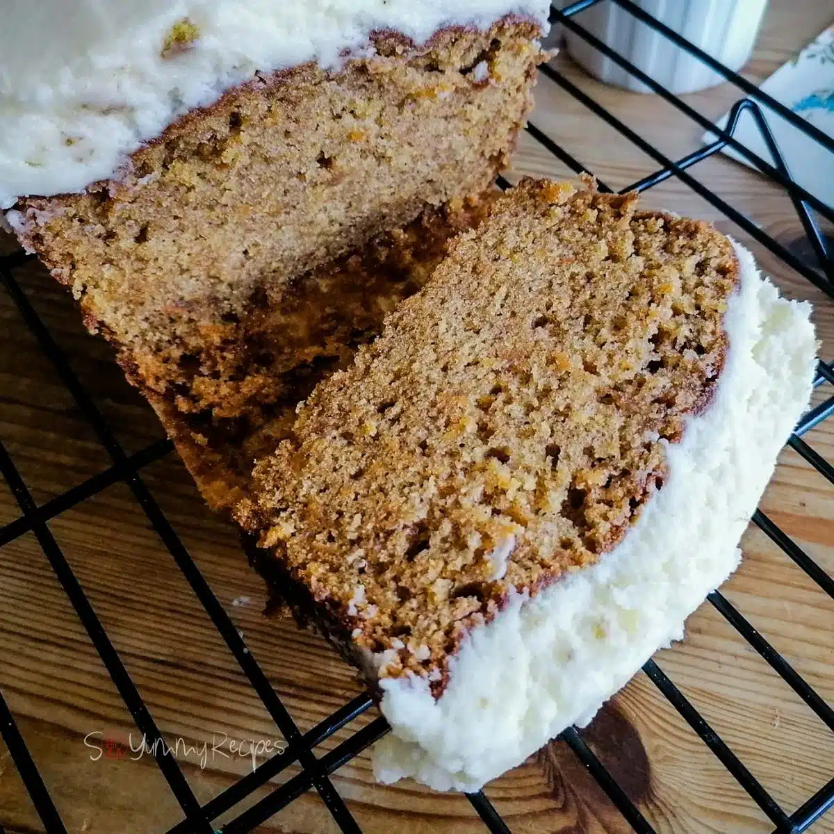 a piece of carrot cake loaf on a cooling rack