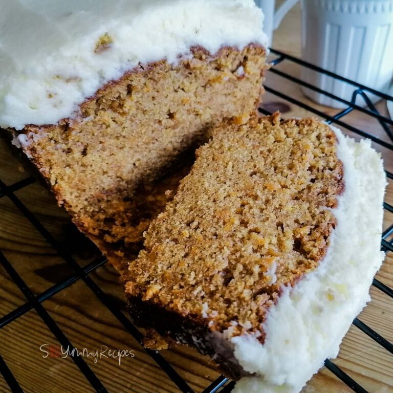 a slice of carrot cake loaf on a cooling rack