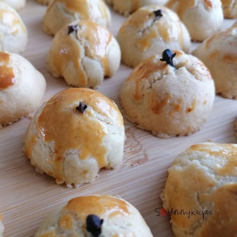 Indonesian Kue Nastar - pineapple tarts on a wooden chopping board.