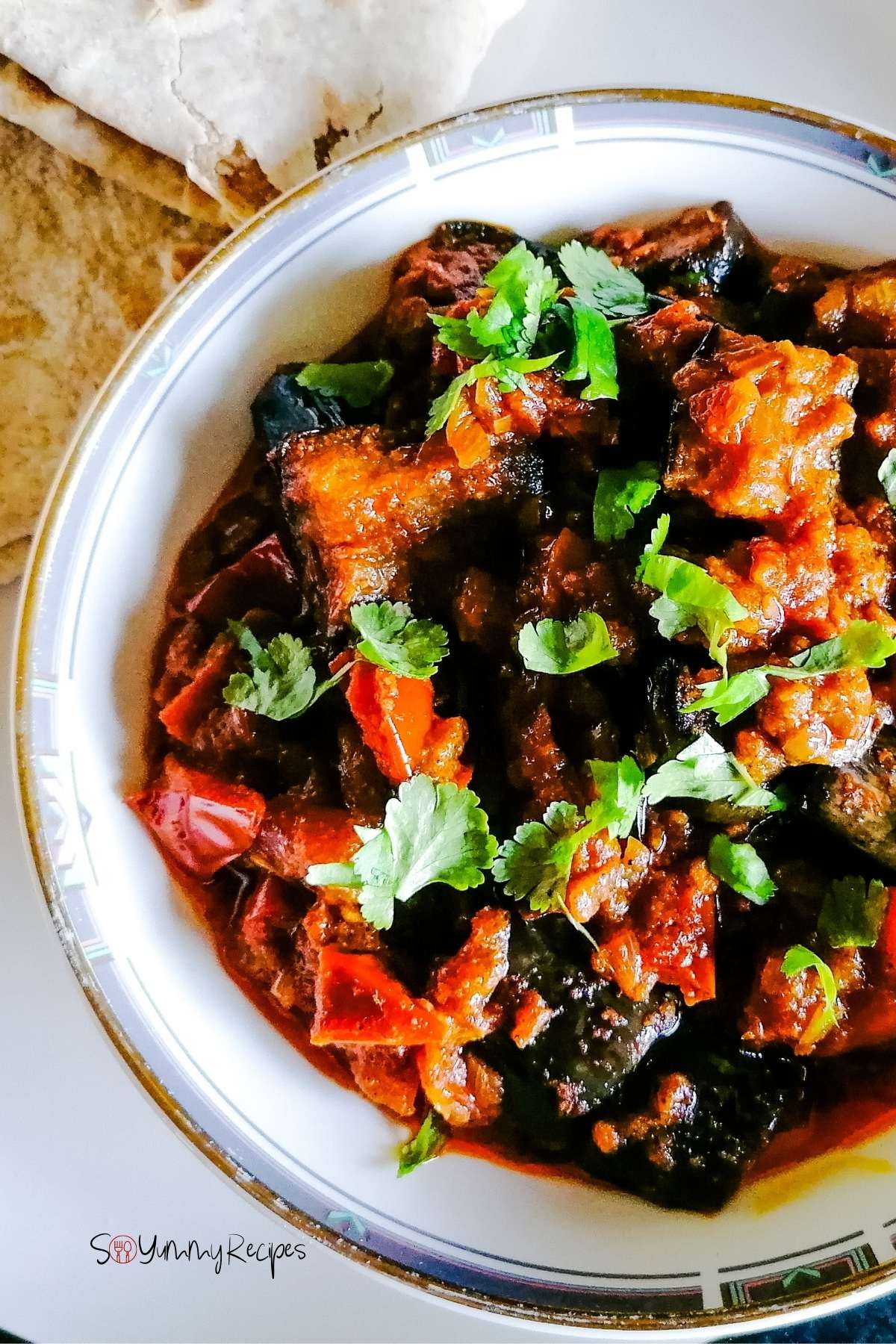 Aubergine curry on a round dish.