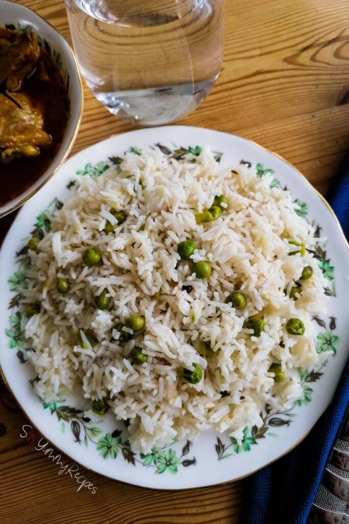 Pakistani Matar Chawal the rice with green peas in a round white dish with green flower pattern. 