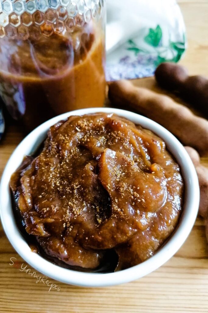 Imli chutney the tamarind sauce in a bowl and a jar.