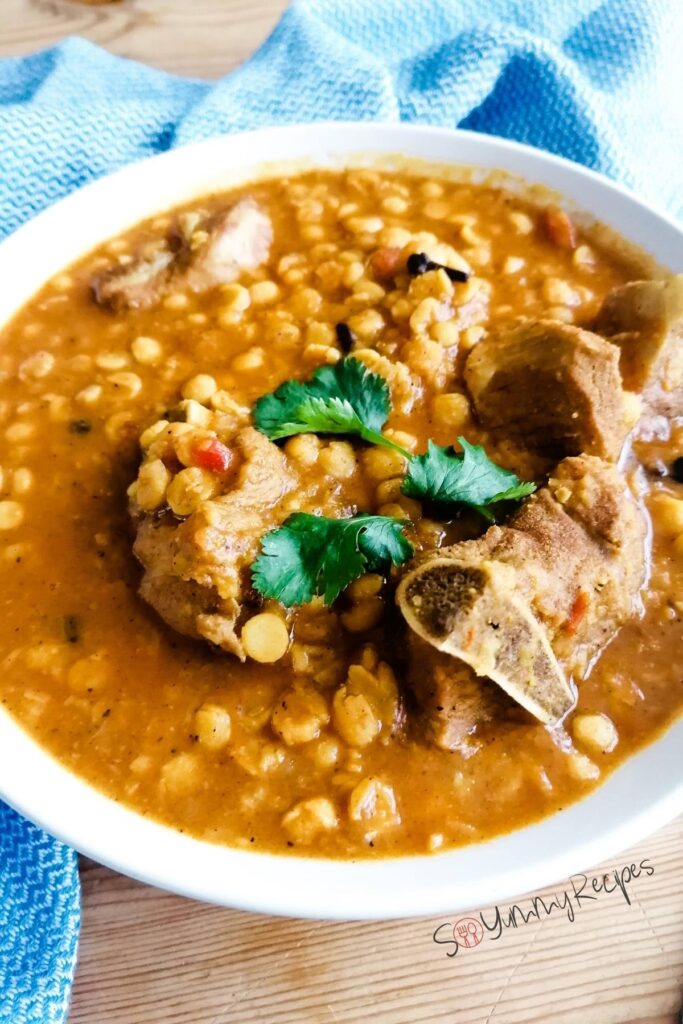 a close up photo of Pakistani lentil and meat curry.