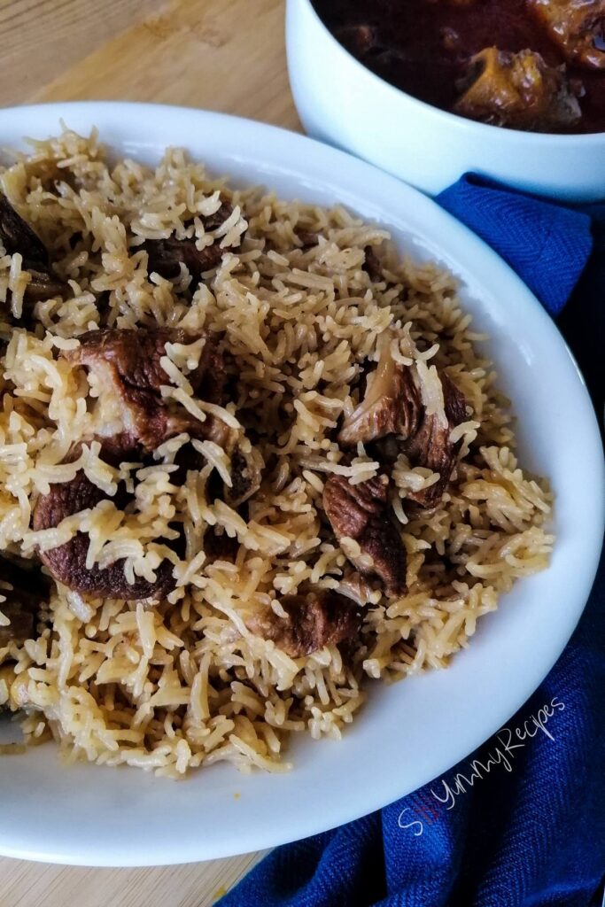 A close up photo of Pakistani lamb pilau rice with blue napkin on the background.