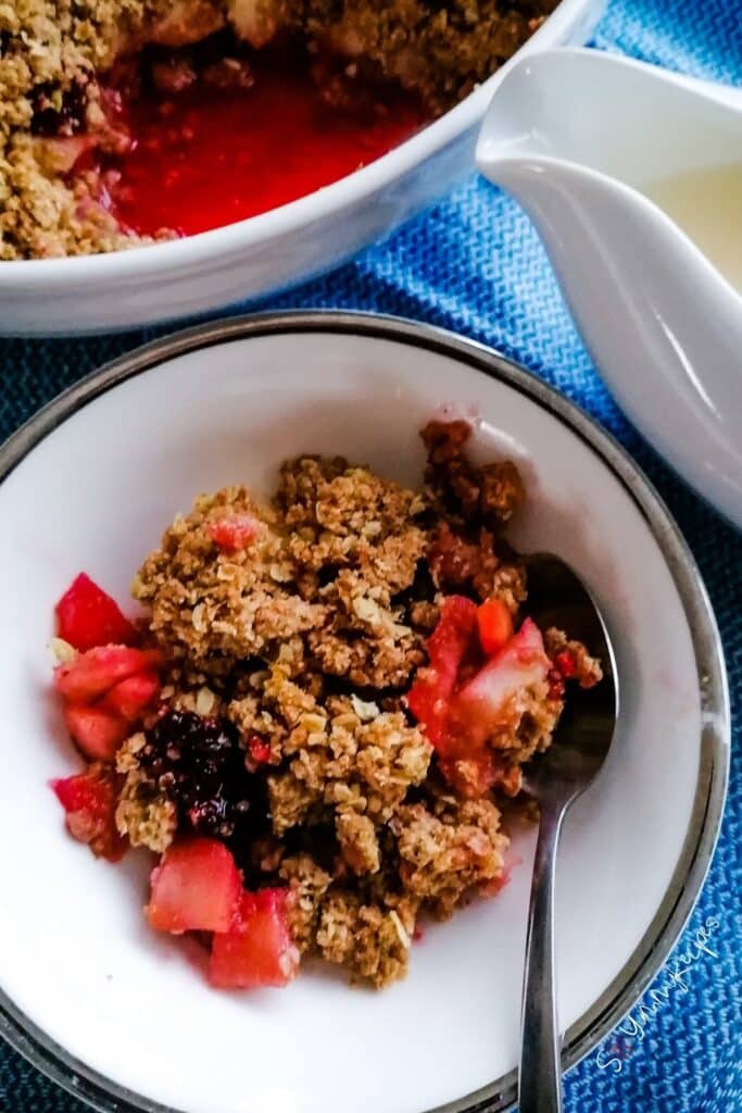A bowl of apple blackberry crumble.