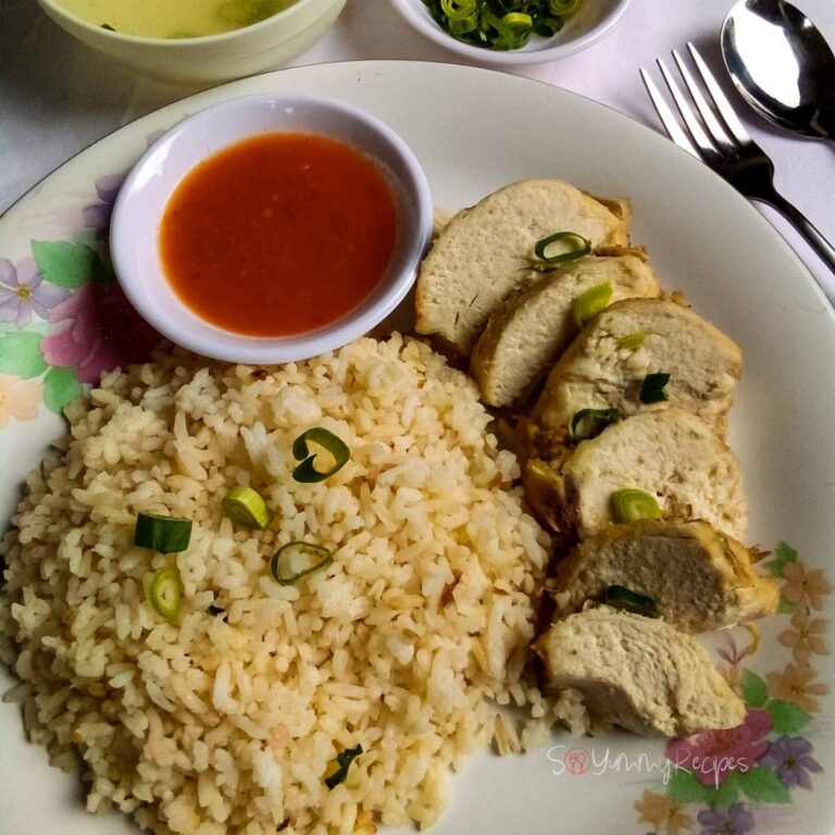 A plate of Nasi Ayam Hainan with a small bowl of chilli sauce.