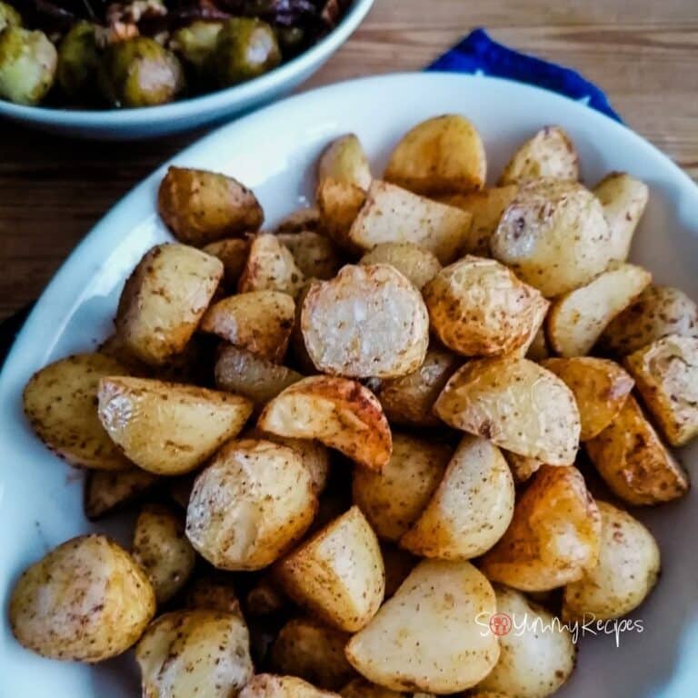 air fryer roasted potatoes on a white serving plate.