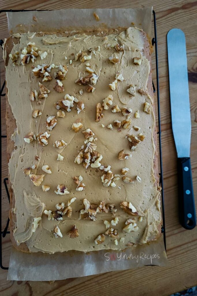 Coffee and walnut traybake with a spatula knife.