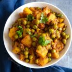 A bowl of Aloo Matar the potato and green pea curry.