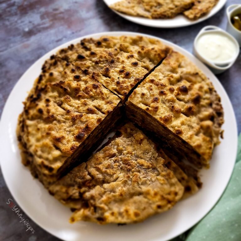 Keema Paratha piled up on a white plate.