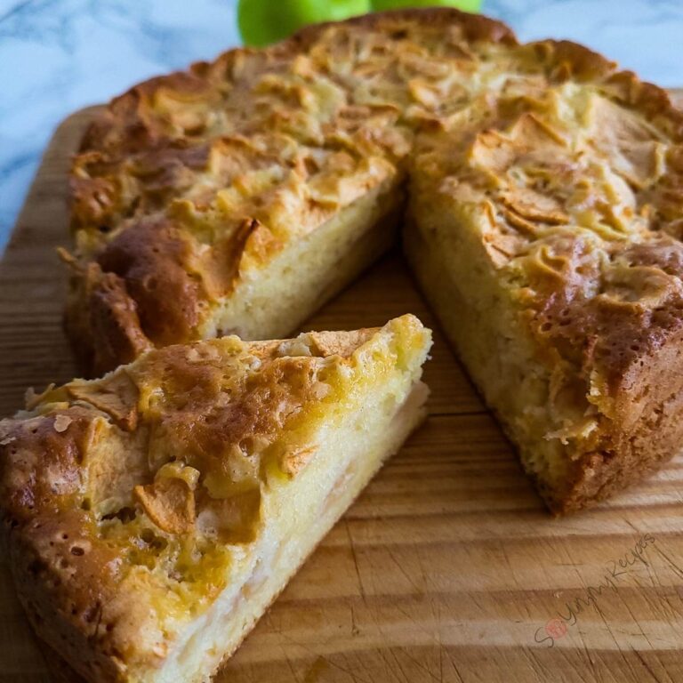 Mary Berry's apple cake on a wooden chopping board.