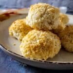 a few coconut macaroons on a side dish plate.