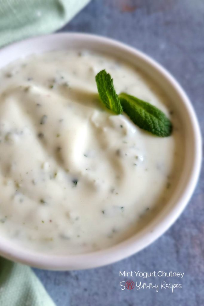 Yogurt with mint in a white bowl.