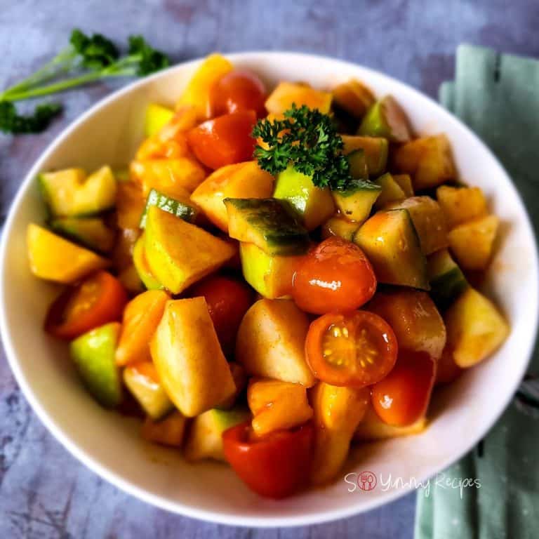 Spicy tomato salad with cucumber, apple, and pineapple.