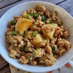Chicken keema with potatoes in a white bowl.
