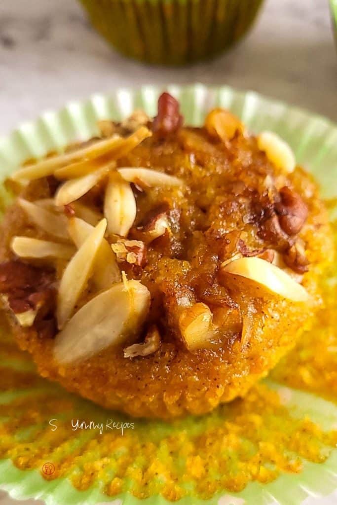 Almond and pumpkin muffin with chopped nuts on the top. 