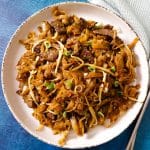 A plate of beef ho fun - the Chinese stir fry wide rice noodles with beef and bean sprouts.
