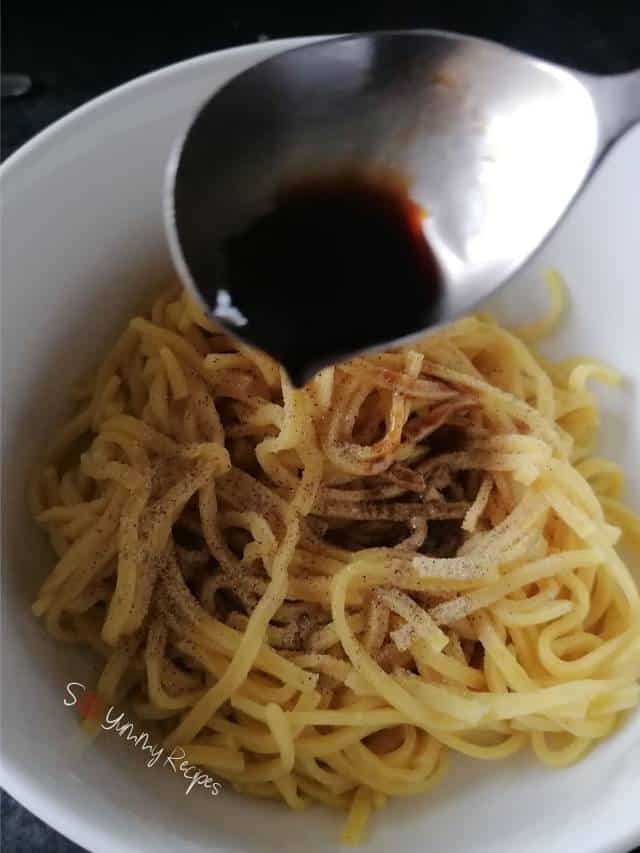 a teasoon of soy sauce over noodles.