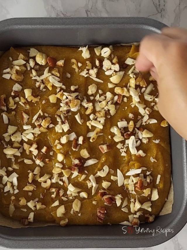 adding chopped nuts over the fudge.