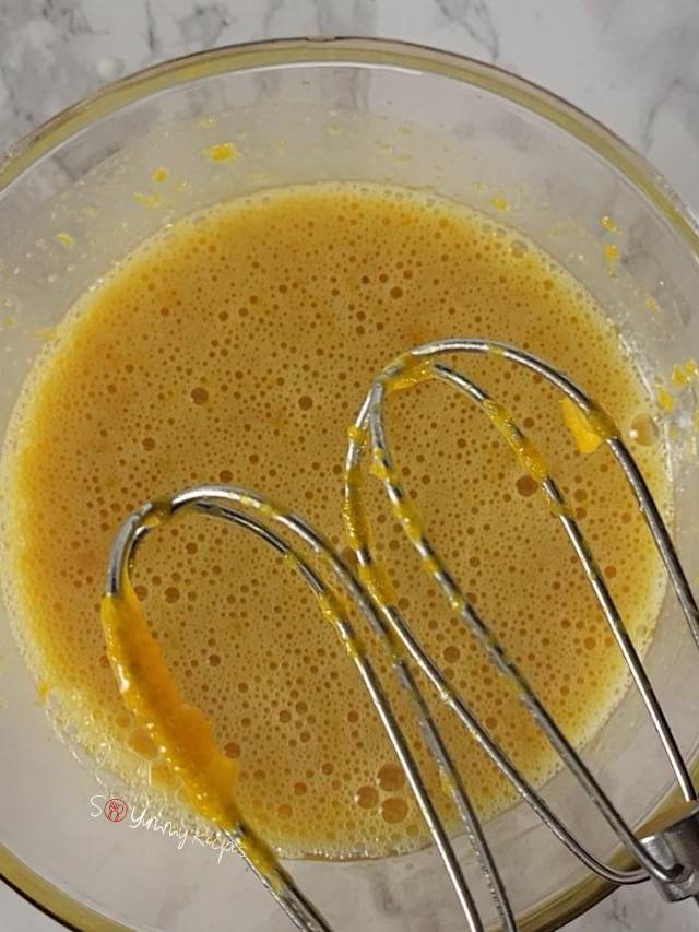 Mixture of pumpkin puree with egg and golden syrup with baloon whisks.