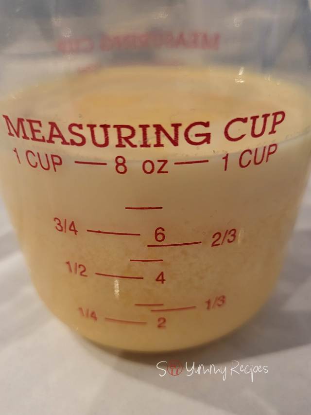 Orange juice and milk mixture in a measuring jug.
