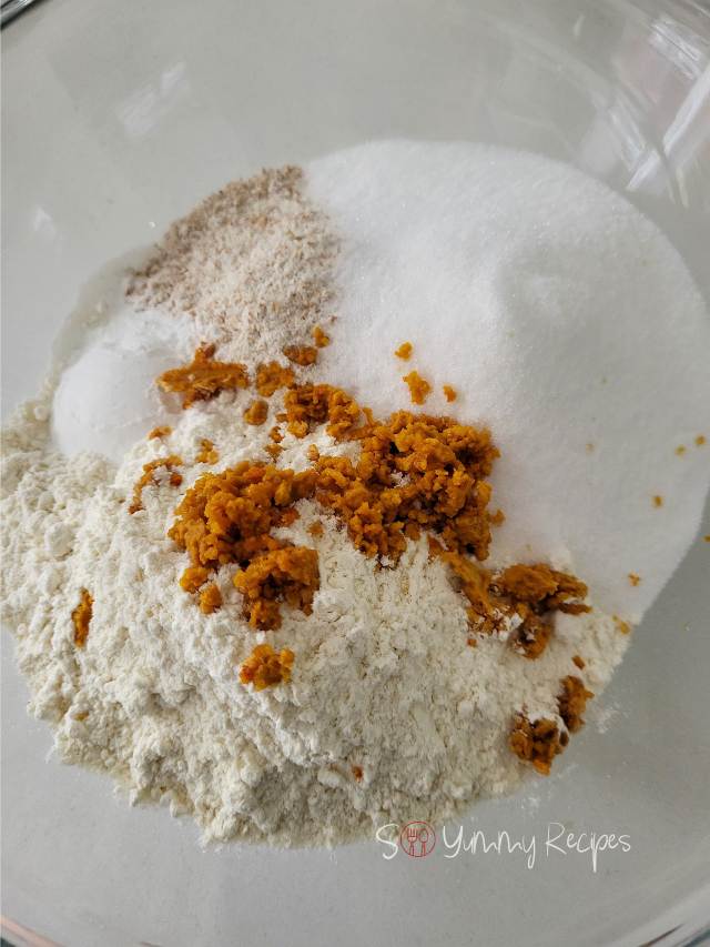 Orange zest on the dry ingredients of orange muffins.