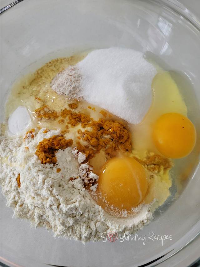 Ingredients for orange muffins in a mixing bowl.