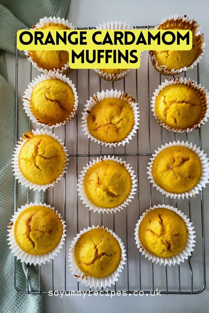 Orange muffins flavored with spicy cardamom on a wire rack.