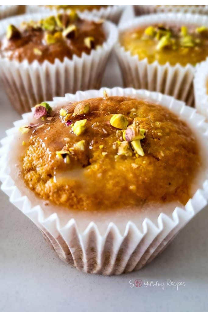 Muffins topped with chopped pistachios.