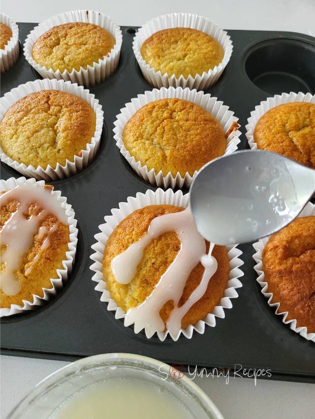 drizzling icing sugar over muffins.