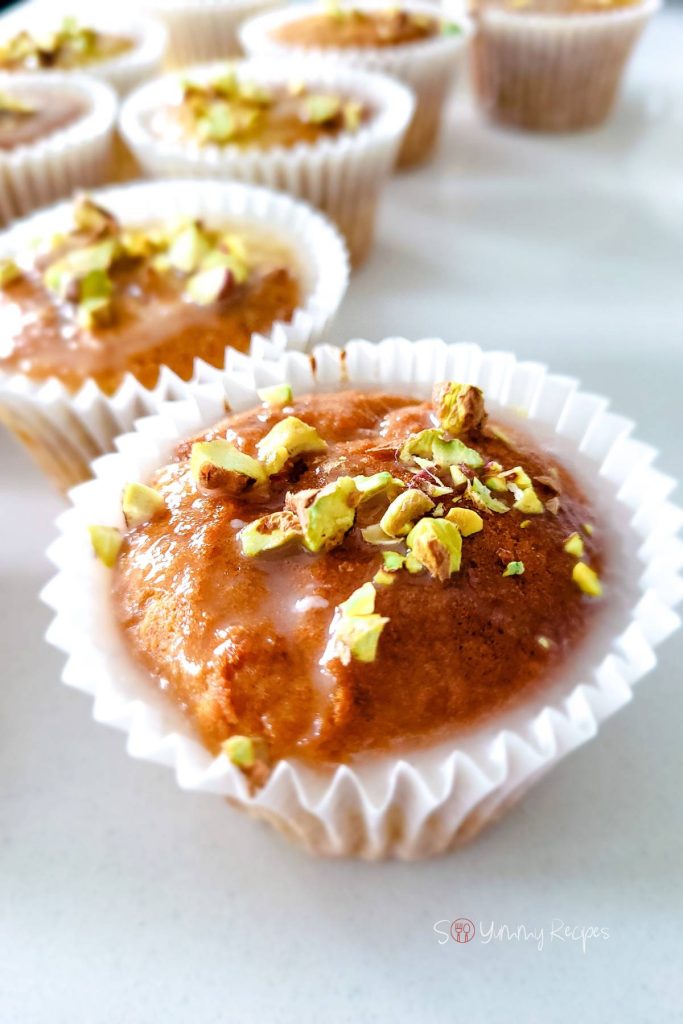 Muffins with pistachio nuts on the top.
