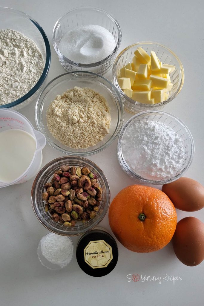 Flour, caster sugar, butter, baking powder, powdered sugar, pistachio nuts, ground almonds, orange, eggs, milk and vanilla extract.