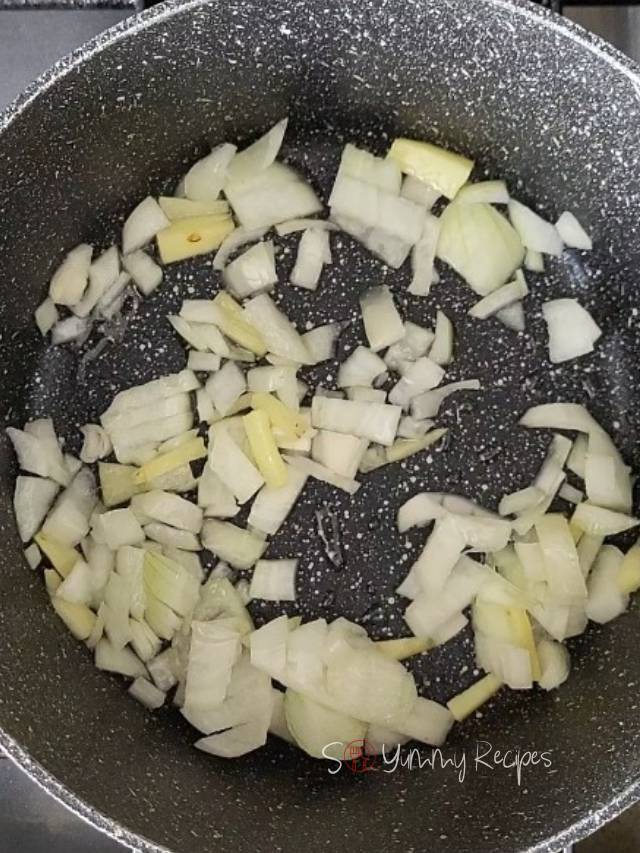 Chopped onion and ginger in a pan.
