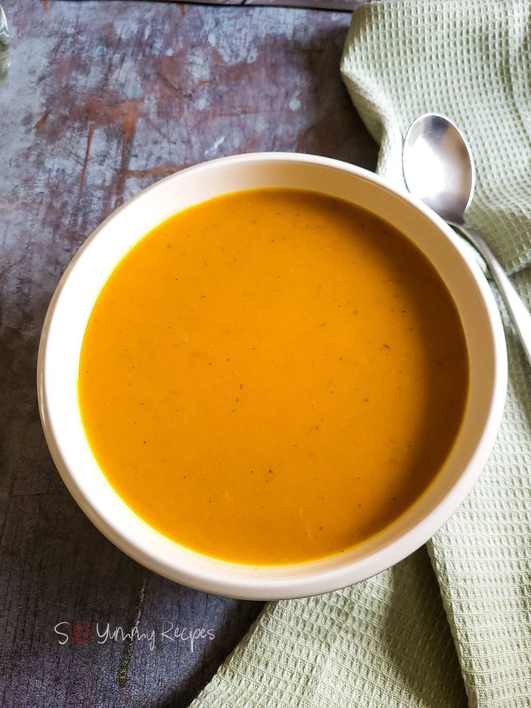 Pumpkin soup in a white bowl.