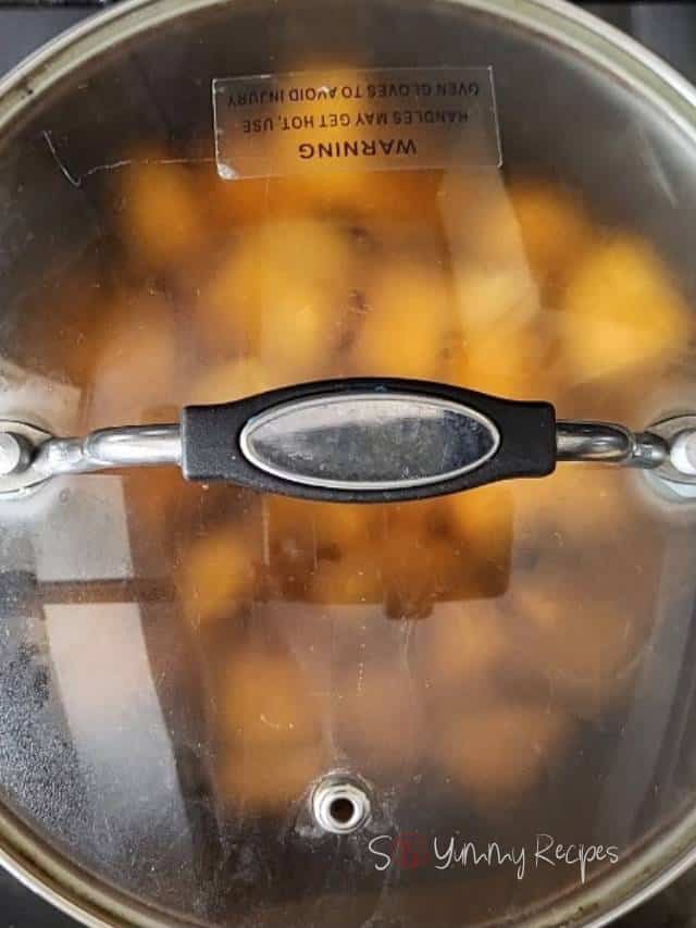 cooking pumpkin in a pan with a lid on.
