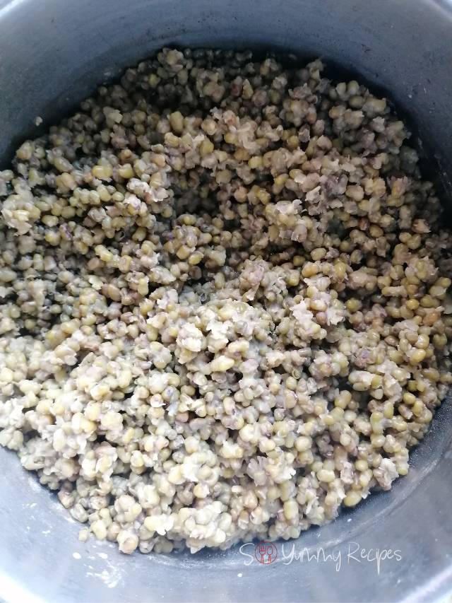 Cooked green moong beans in a pan.