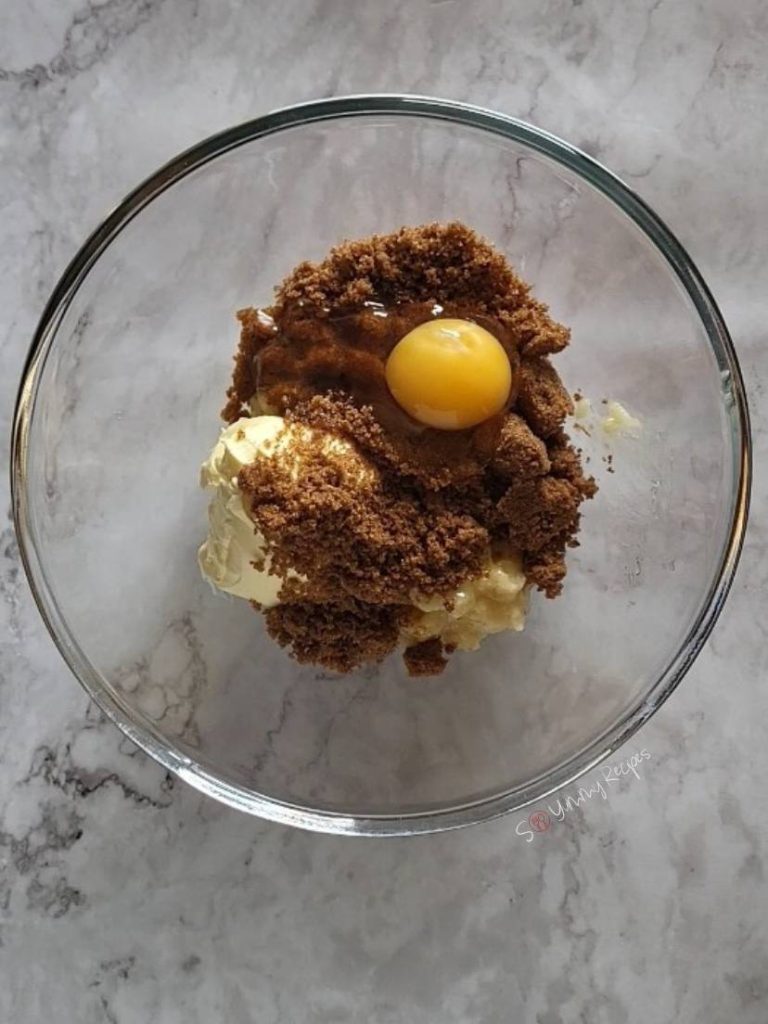 Egg, brown sugar, and margarine in a bowl.