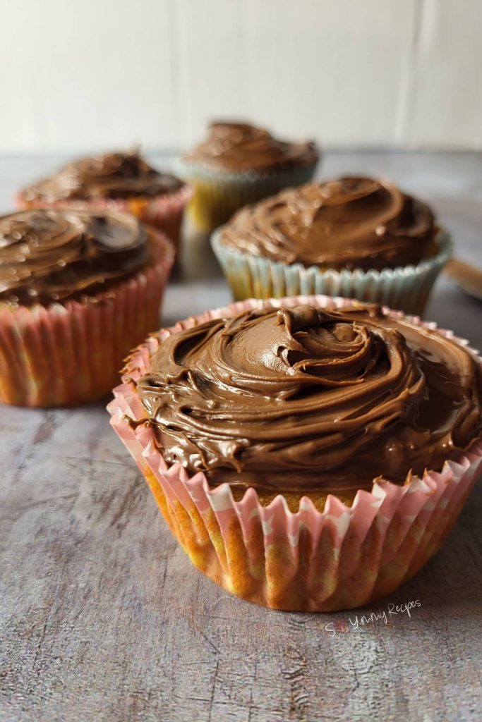 Banana cupcakes topped with chocolate frosting.
