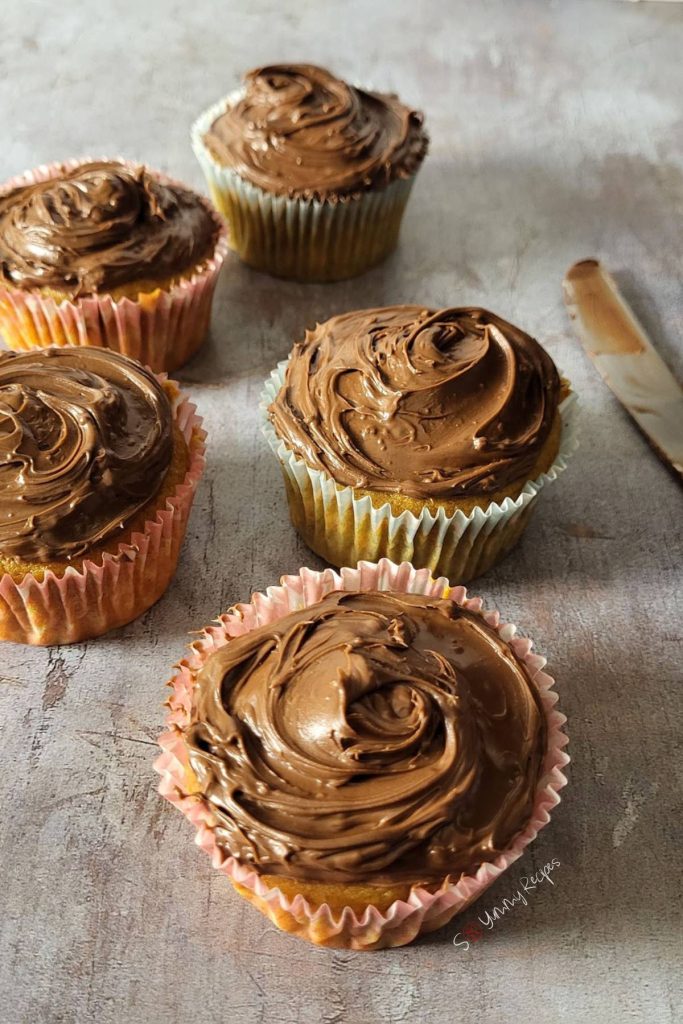 cupcakes covered with chocolate frosting.