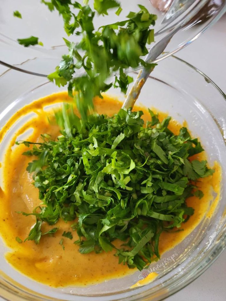 chopped cilantro on pakora batter.