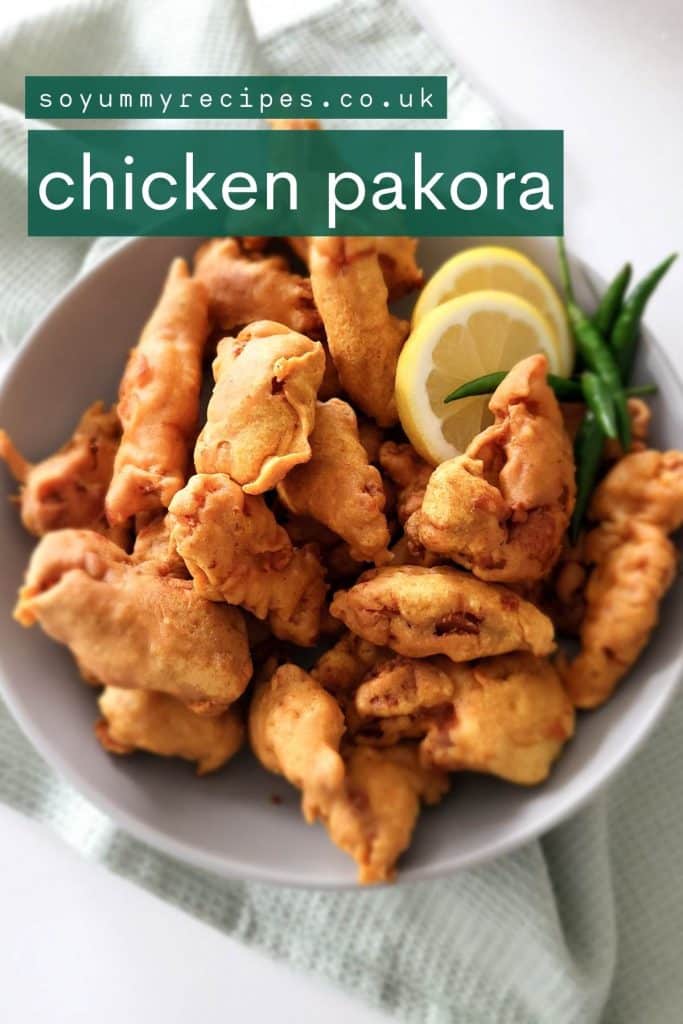 Pakistani chicken fritters on a deep plate with lemon slices and green chilies.